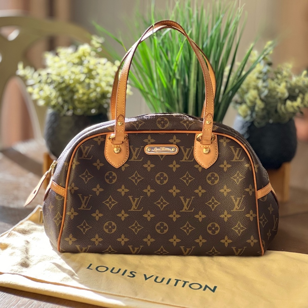 Louis Vuitton's petit Montorgueil is rendered in Monogram coated canvas.